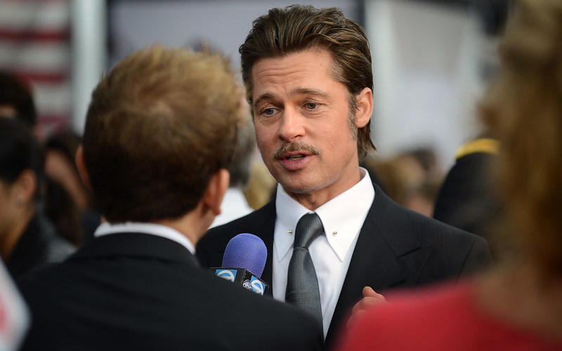 Brad Pitt in suit answering questions at press event