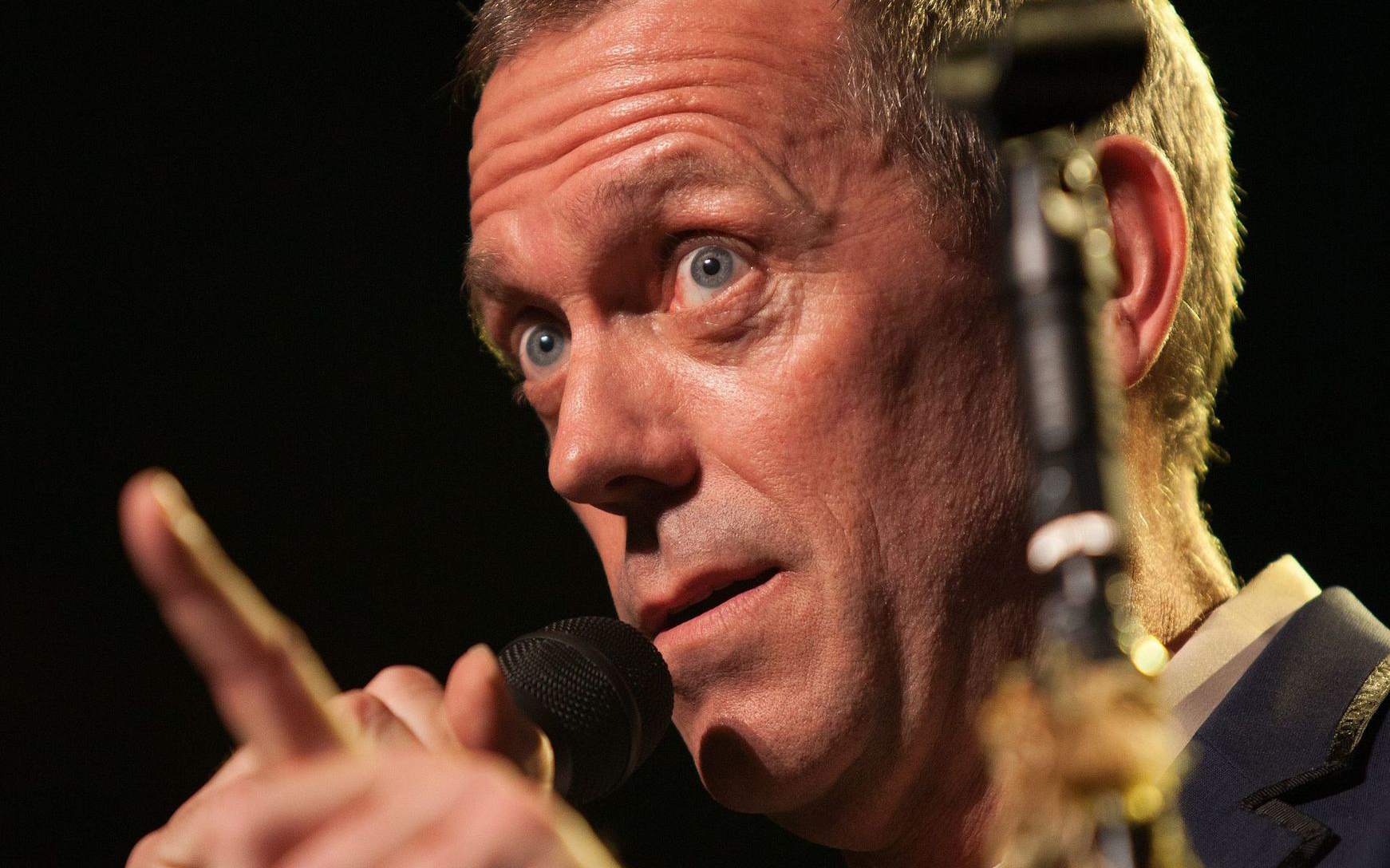 Hugh Laurie with microphone answering questions