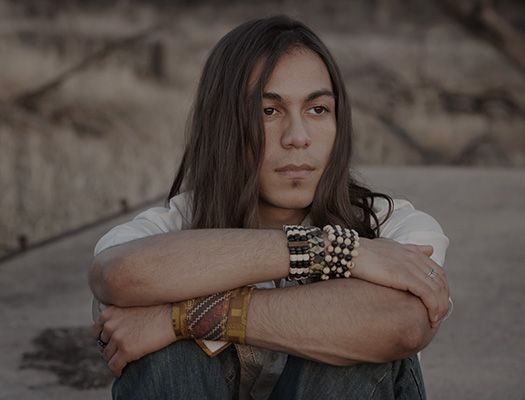 Young man sitting with arms crossed