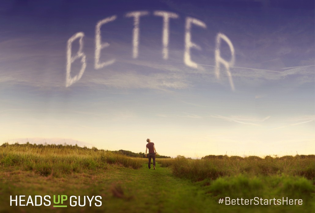 Man in field with "Better" written in sky