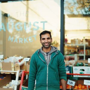Gogan in front of grocery store he manages
