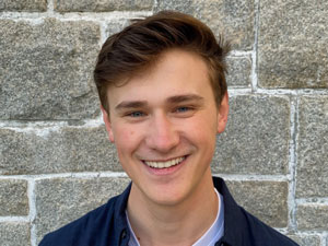 Headshot of Aidan smiling