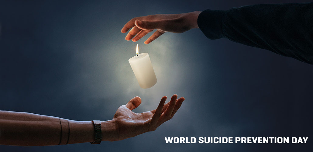 A candle balances between to hands - concept photo