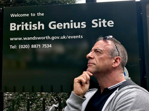 Photo of Joe in front of "British Genius Site" sign
