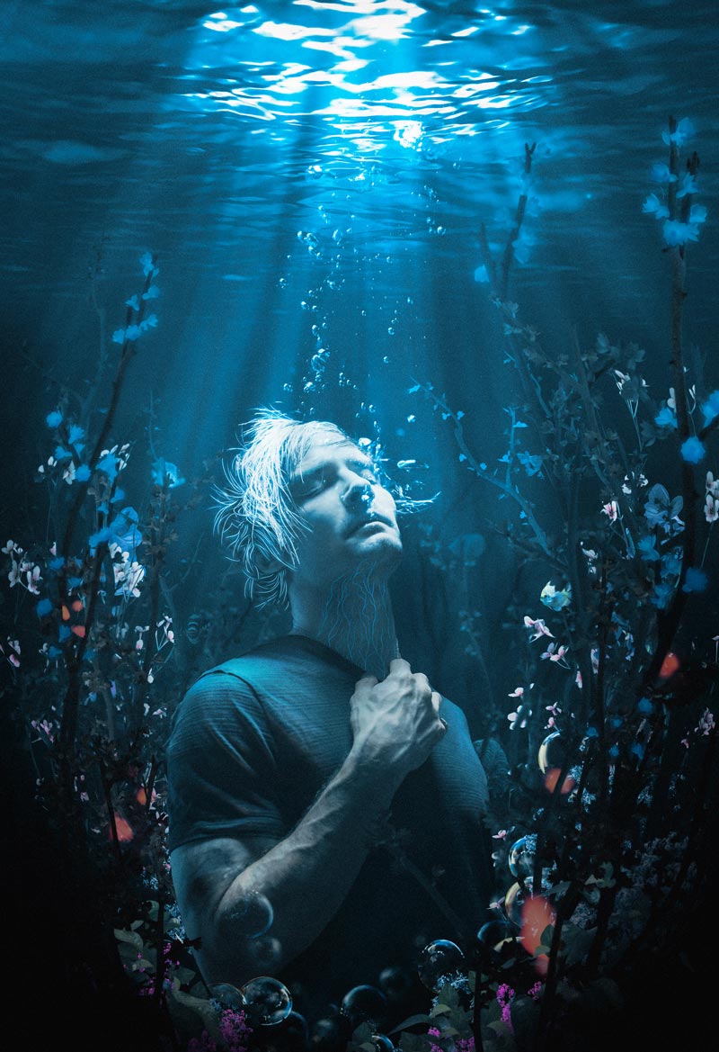 A man breathes underwater facing up