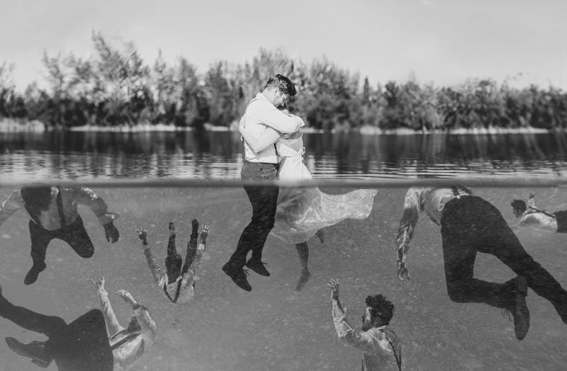 Concept photo, a couple embraces above water with dark thoughts below 