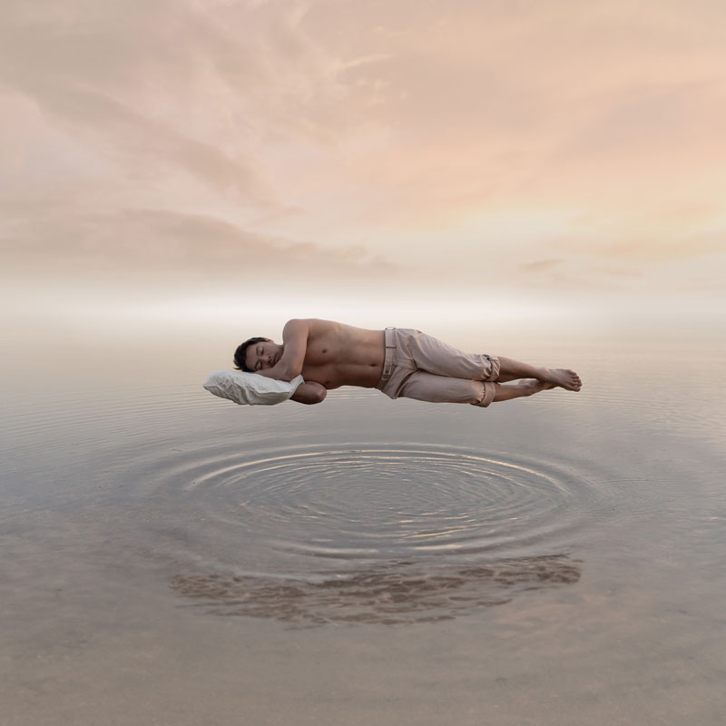 Man sleeping and floating above water