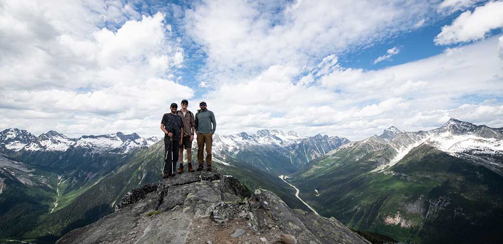 Andrew and Friends atop mountain peak