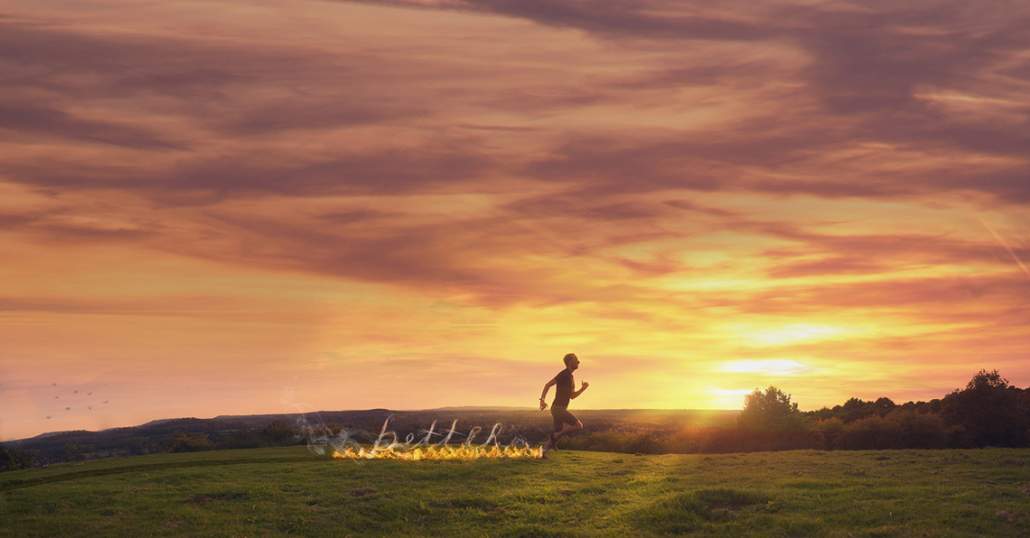 Man running with better written in fire behind him