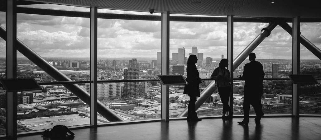 People meeting in office space with large windows and city view