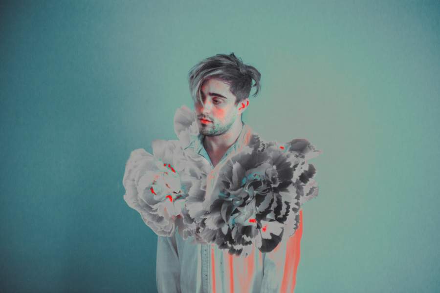 Conceptual self portrait of Ricardo, with flowers and teal and orange colours