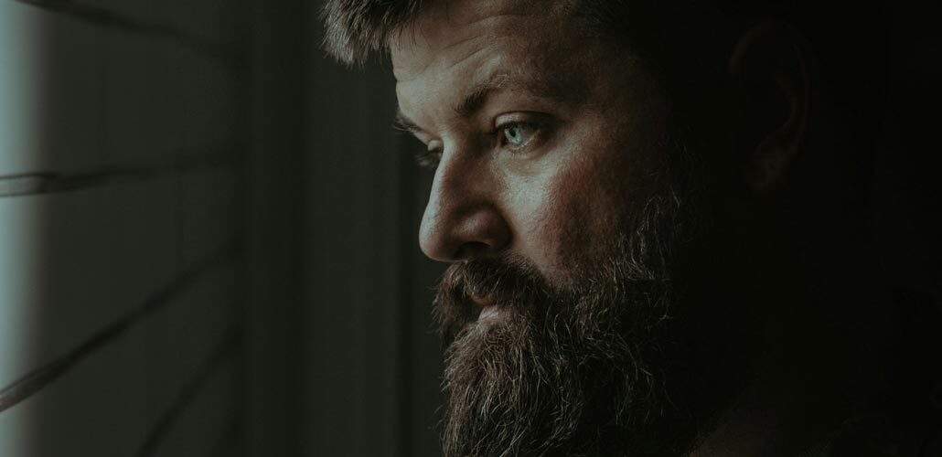 Close up of bearded man looking down