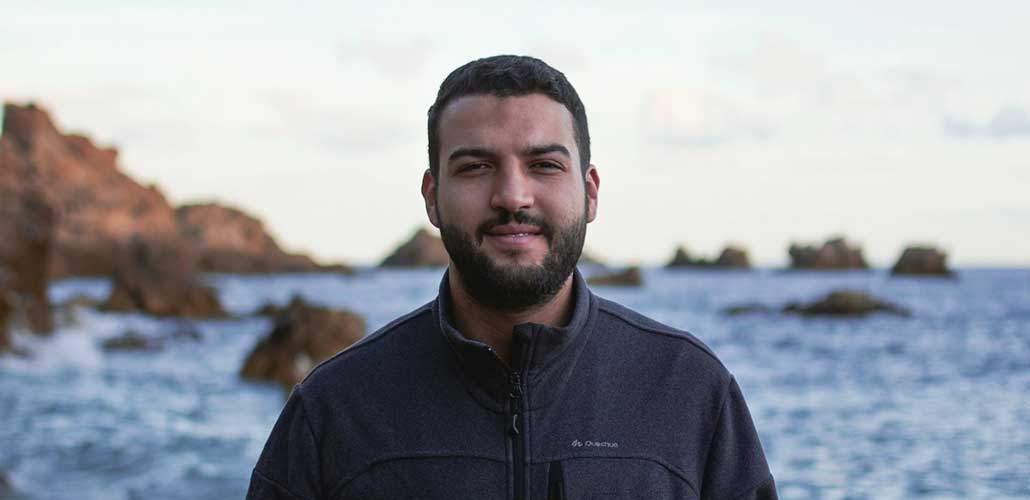 Bearded Man in Black Jacket Near Water