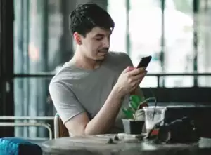 Man looking at financial app on his phone