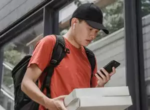 Stressed man looks at phone